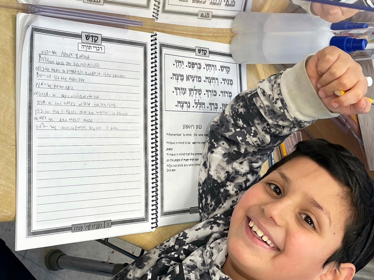In CAHAL’s grade 4-5 class at YOSS, boys learned divrei torah and wrote them in their Haggadahs to read at the Seder.