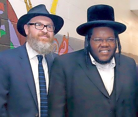 Chabad of the Beaches Rabbi Eli Goodman with rapper Nissim Black at a benefit concert in Long Beach in 2018.