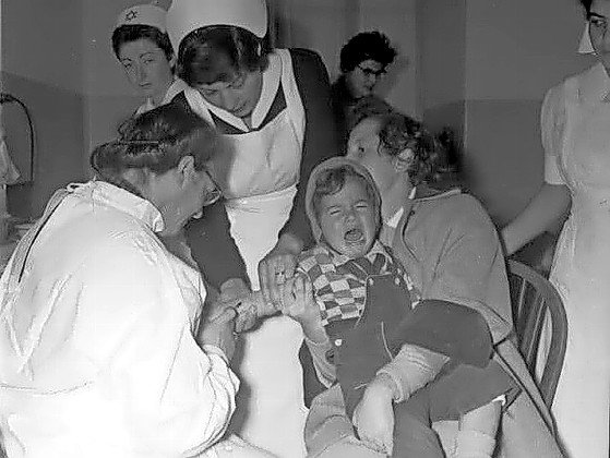 A child afflicted with polio is treated at an army base in Israel, during a visit by Hadassah representatives in 1954.