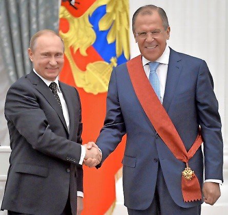 Russian President Vladimir Putin with Russia’s Foreign Minister Sergey Lavrov being awarded the Order of Service to the Fatherland, 1st class, at the Kremlin in Moscow on May 21, 2015.