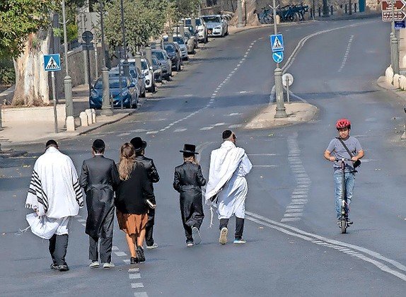 Walking and scootering on empty Jerusalem roads on Yom Kippur, Sept. 16, 2021.