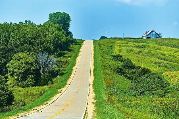A road in Iowa passes one of the state’s famous corn fields.