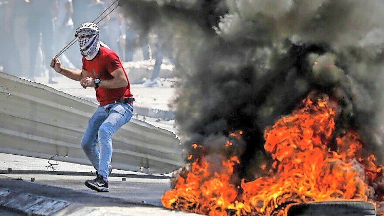 Palestinian rioters attack Israeli security forces in Bethlehem in 2021.