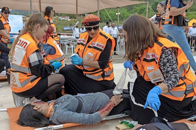 United Hatzalah women volunteers treat a “victim” in a simulation of a mass-casualty training event.