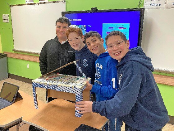 HALB eight grade boys showing what they did for their STEM project