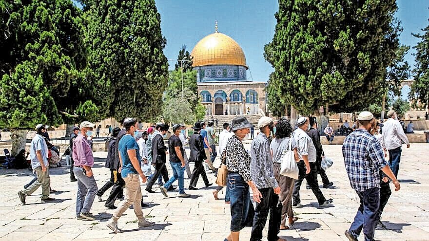 Israeli security forces escort a group of religious Jews as they visit the Temple Mount in Jerusalem’s Old City after it was reopened to the public on May 31, 2020.