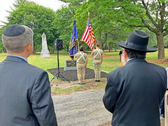 Members of VFW Post 9592 present the colors at Friday’s ceremony, as Touro Law Professor Samuel Levine and Rabbi Anchelle Perl of Chabad Mineola look on.