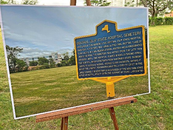 At Friday’s rededication, a picture displays a roadside marker with information about the Central Islip State Hospital Cemetry. The hospital grounds stretched from Southern State Parkway to Suffolk Avenue.