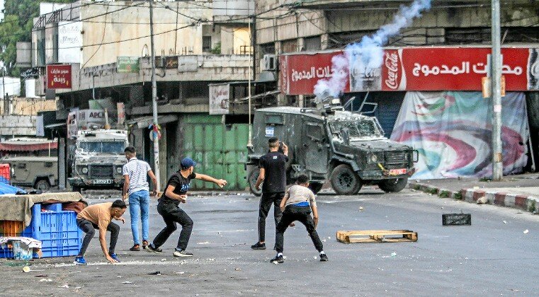 Palestinians clash with Israeli security forces during a Military operation in Nablus on July 7.