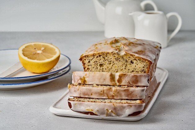 Lemon loaf with poppy seeds, white icing and citrus zest.