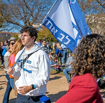 SAR senior Abe Bensoussan marching with a “one heart” Israeli flag.