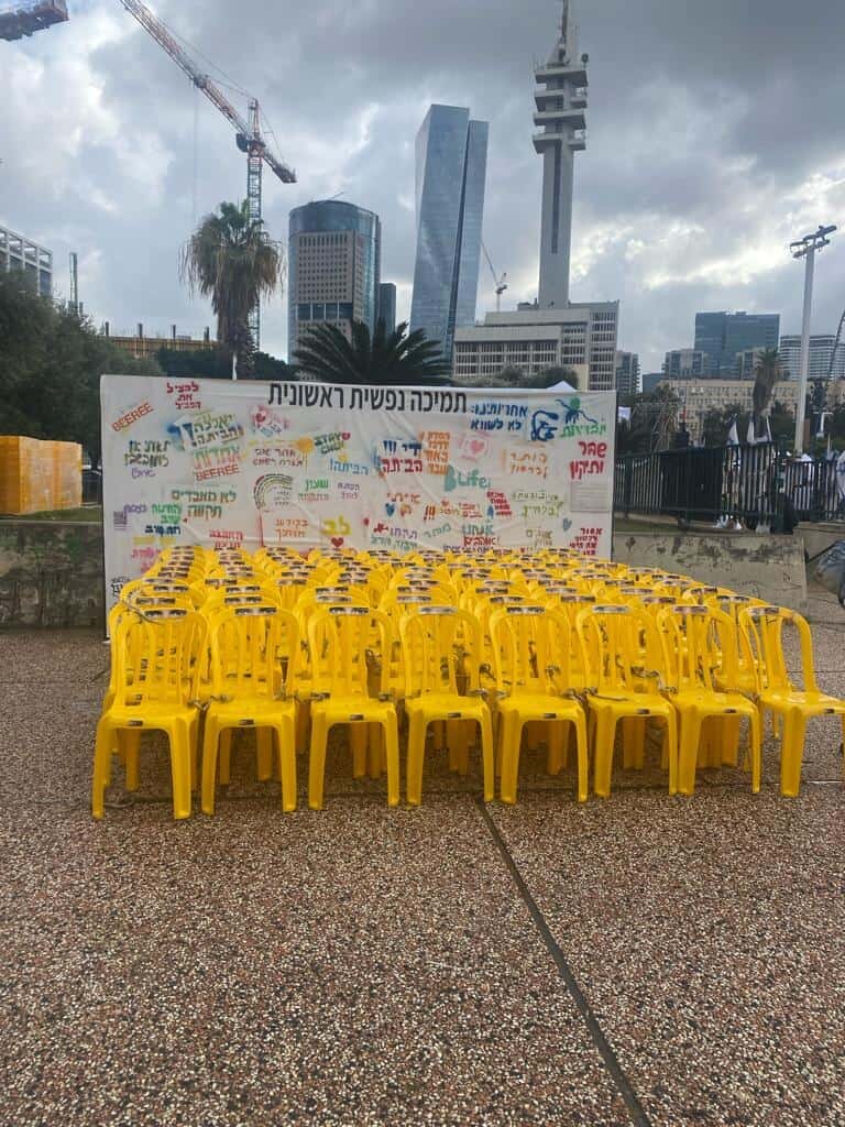 Chairs tied together in front of a sheet with messages of hope addressed to the hostages in Gaza and prayers for their return, at Hostage Square in Tel Aviv, Jan. 12.