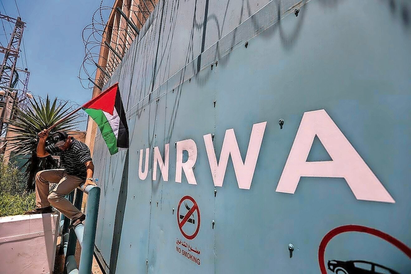 A Palestinian man outside the UNRAW in Gaza City protests cuts to aid on June 20, 2023.