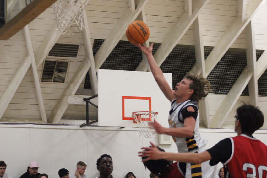Zane Carver of the varsity Broncs lays up a shot in the game played this past Friday.
