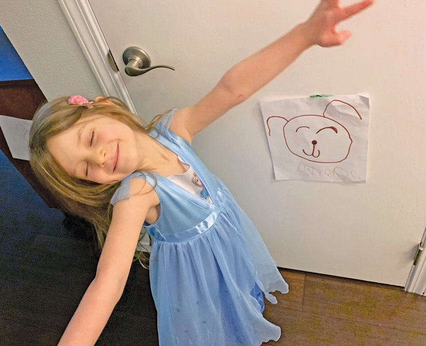 As part of a clever multi-media marketing program, 5-year old Violet Bruemmer has decorated the walls of her house with mini-posters of &quot;snuggly and loveable&quot; dogs. She is certain that 2021 will bring not only some relief from the pandemic, but a much-needed new dog playmate.
