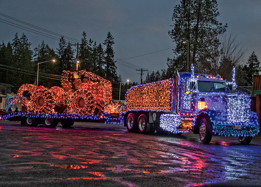 John Yaggi of Fell Rite Timber Falling on his way to the 2nd Annual Christmas Parade in Home after installing 26,000 lights, totaling 2&frac12; miles of string, to light up his &rsquo;94 Kenwood and 518 Cat Skidder