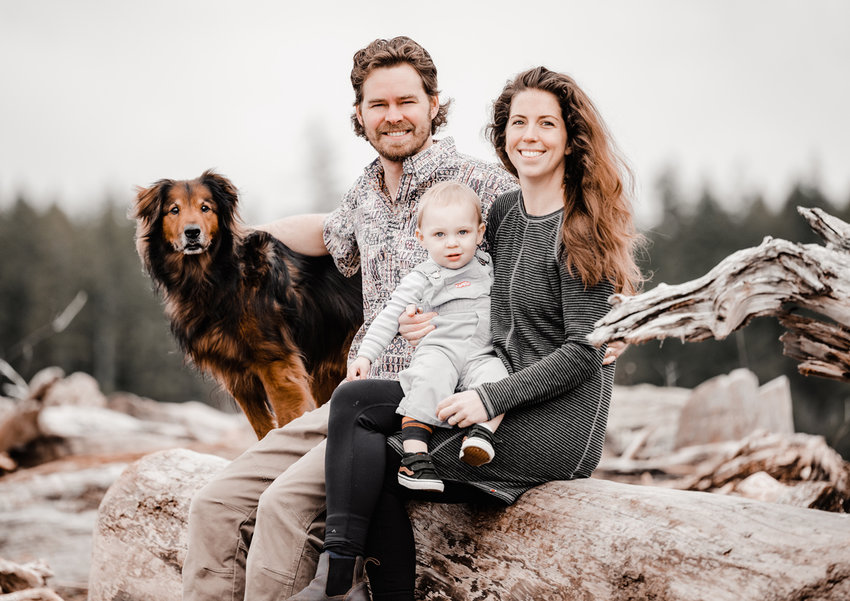 Laura Harbaugh with husband Stanton, baby Hendrix and their dog Nuggen on the beach at Olman Point.