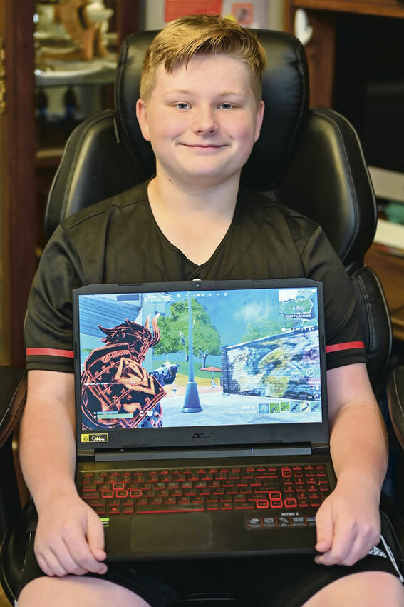 Bryce Hoover at home with one of his Fortnite &ldquo;skins.&rdquo;