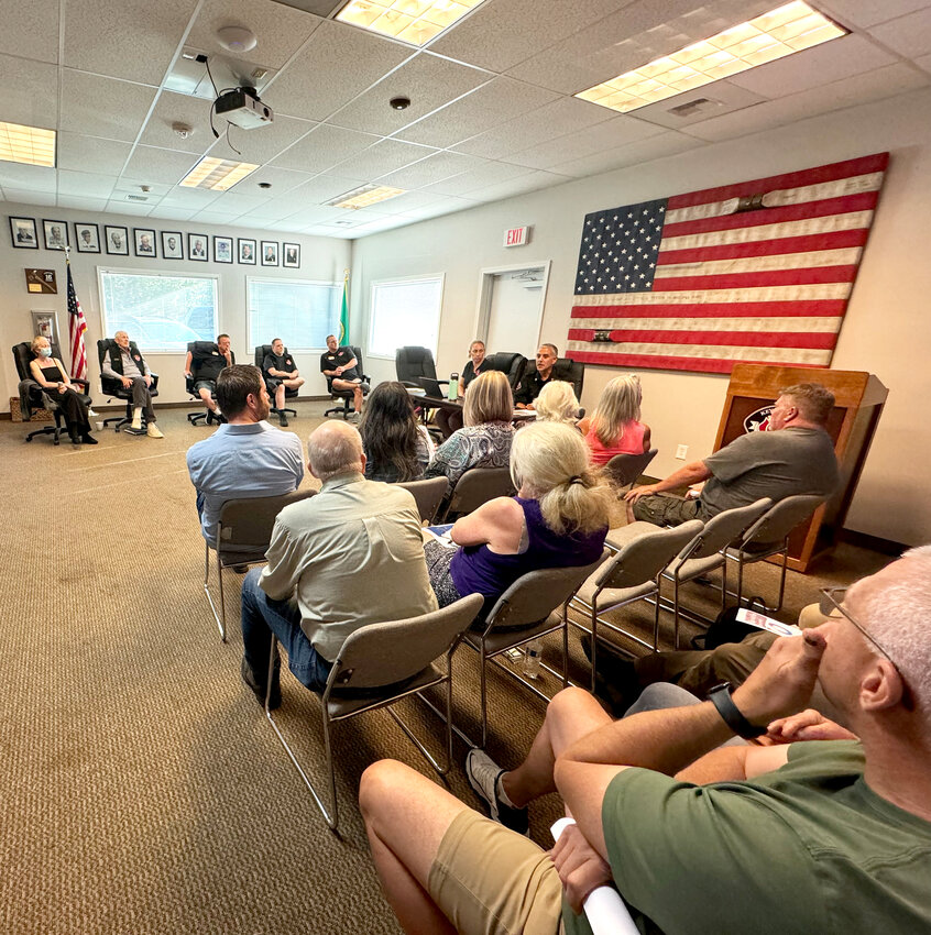 The fire commissioners and staff with community members at the July 10 meeting.