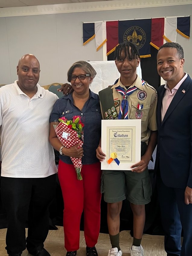 Stephen and Jackie Green and their son, Mekhi, with County Legislator Carrié Solages at the Eagle Court of Honor ceremony at Wesley United Methodist Church in Franklin Square.