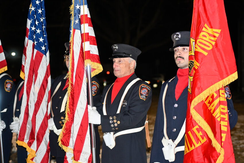 Members of the Valley Stream Fire Department's color guard stand and take guard.