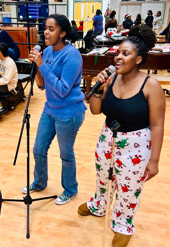 Lynbrook High School’s Culture Club seniors Aurore Baptiste, left, and Bella Nanyanzi sang at a karaoke night in December. 