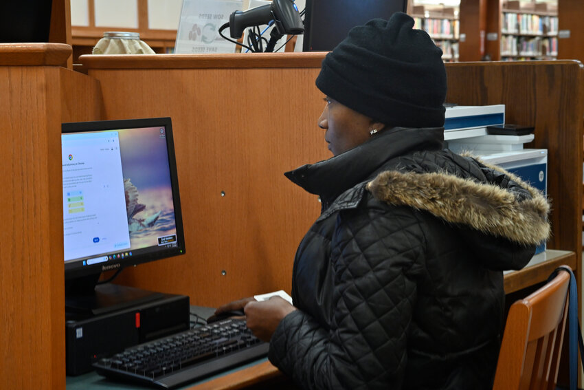 While patrons like Michelle Parcells can use the library-provided computer in a separate cubicle, there is not private space for groups.
