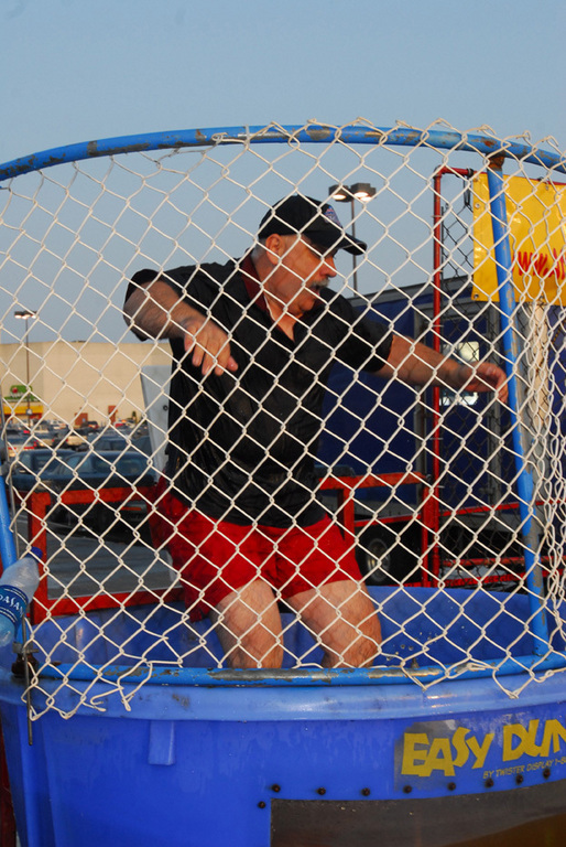 Police Officer Ed Mallay takes a spill in the dunk tank outside Green Acres Mall.