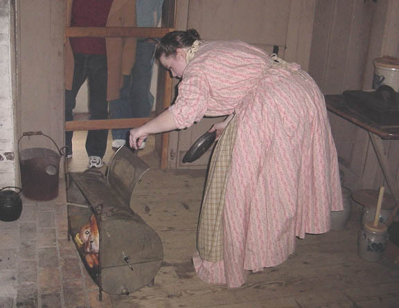 Thanksgiving 19th century-style: Checking the turkey at Old Bethpage Village Restoration, in a demonstration of some of the foods prepared for an old-fashioned holiday 
celebration.