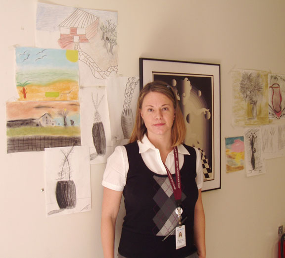 Courtesy LBMC
Supervisor Kristen Snipp with drawings created by clients in art therapy at the Chemical Dependence Unit at Long Beach Medical Center.