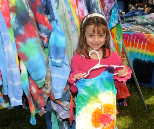 Kiara Contos shows off the elaborate tie-dye garments at the Oceanside Chamber of Commerce’s County Fair last Saturday at Schoolhouse Green. More than 50 local merchants and businesses were at the event, which featured an inflatable slide, games and, of course, cotton candy.