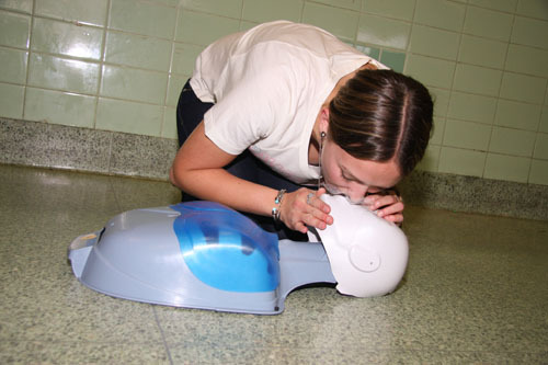 Kayla Babbush, a Kennedy sophomore, demonstrates cardiopulmonary resuscitation on a dummy.