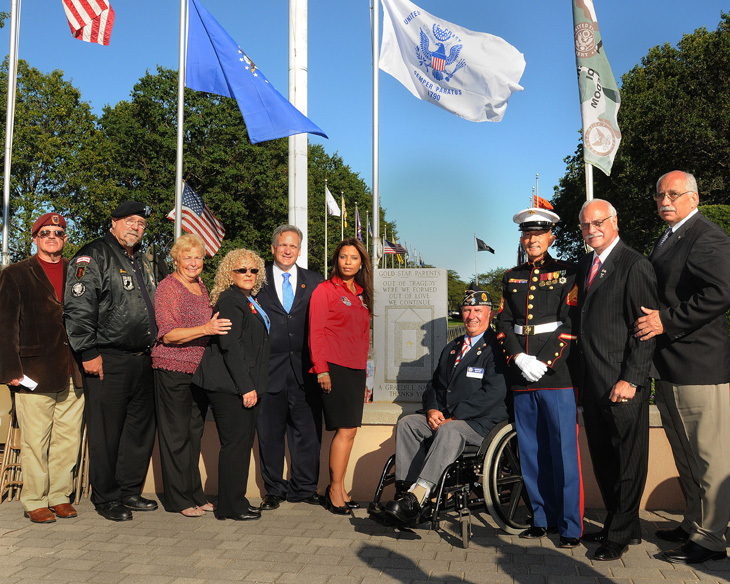 Pat Yngstrom, Director of Veterans Services for Nassau County; Joe Ingino, President of the Vietnam Veterans Chapter 82 of Nassau County; Legislator Rose Walker; Gold Star Mother and Program Coordinator Emily Toro; Nassau County Executive Edward Mangano; Gold Star Mother and Program Coordinator Nancy Fuentes; Andrew Booth, Commander of the Second Division of the American Legion; Paul Masi, Vietnam Veterans Chapter 82 of Nassau County; Legislator Joe Belisi and Legislator Dennis Dunne.