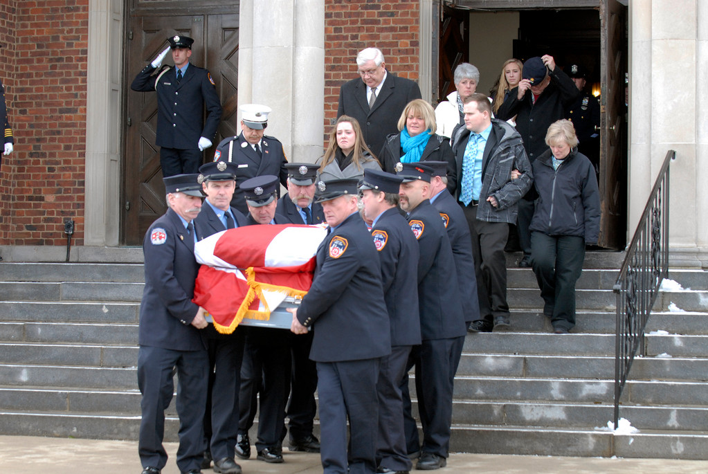 The body of firefighter William Quick was carried from St. Ignatius Martyr Church after Quick’s funeral 
service last Saturday.