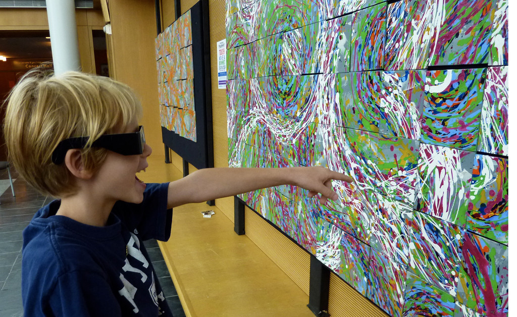 A visitor to Long Island Children’s Museum uses 3D glasses to explore this unique exhibit featuring Alli Berman’s interactive PuzzleArt.