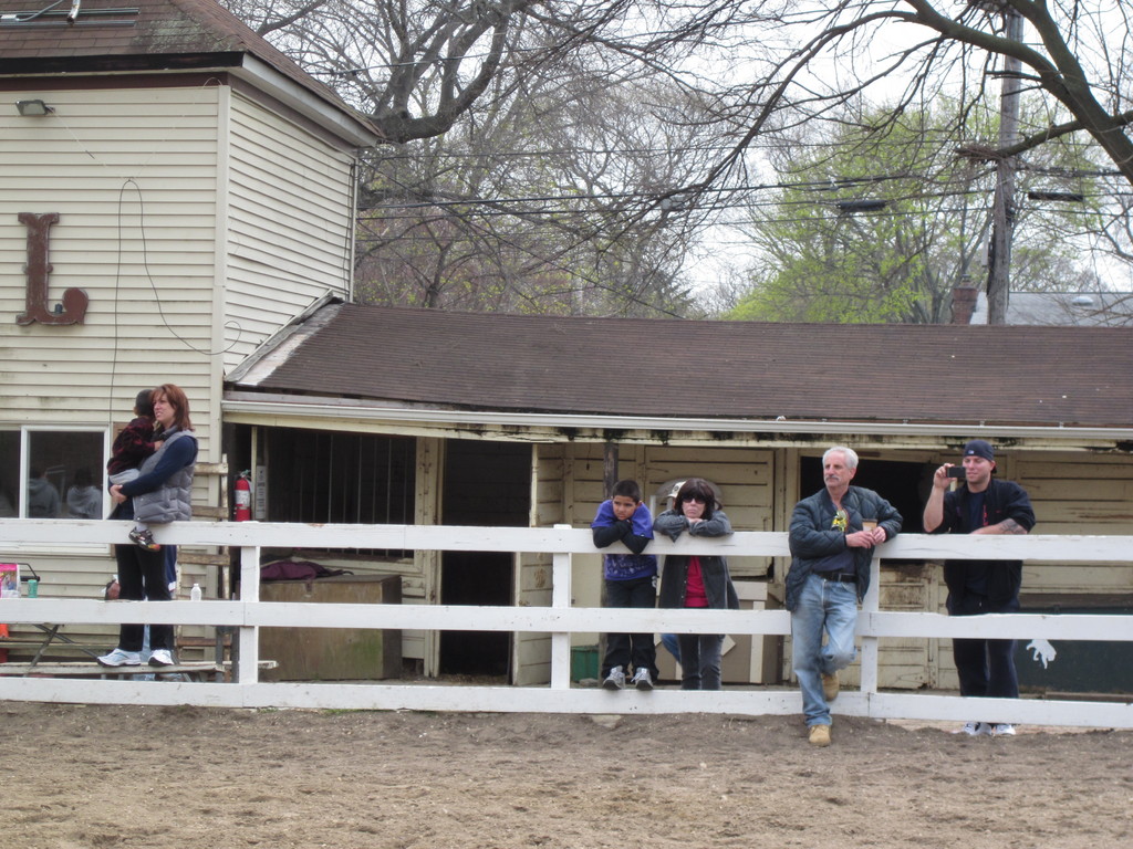 Equestrians watched quietly as the main barn came down.