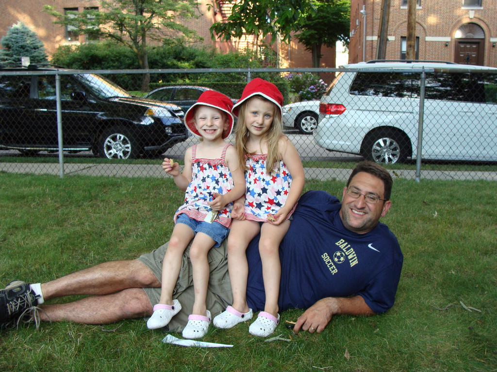 Twins Francesca and Lucia Palumbo, 4, of East Rockaway have some fun with their dad, Michael.