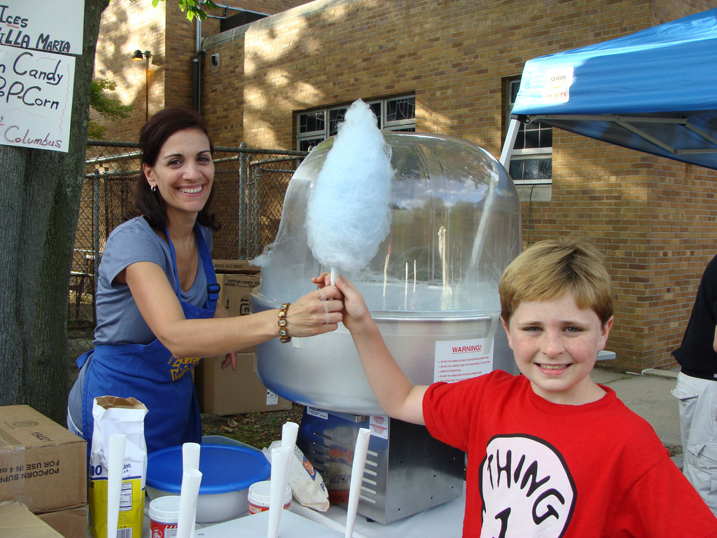Claudina Barbella served cotton candy to a hungry Sean Denis, 9.