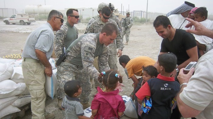 The local children gathered around the soldiers as they handed out supplies.