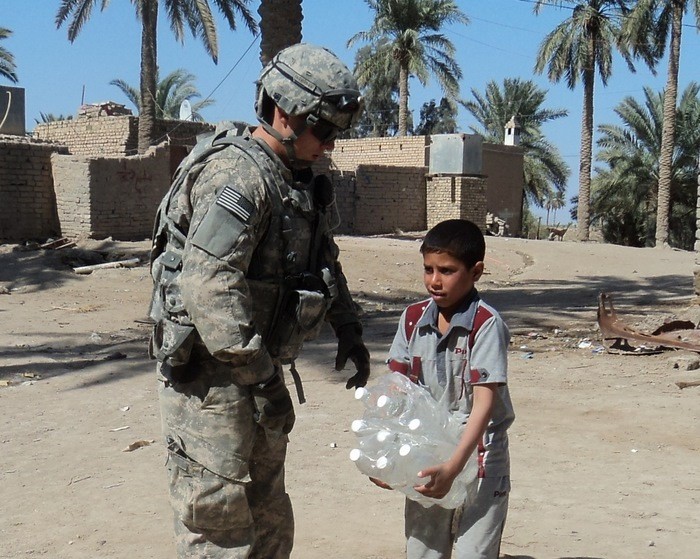 Along with my platoon, we try to help the Iraqi Security Forces in delivering a higher quality of life to the Iraqi populous.  I am pictured here with a young Iraqi boy, giving fresh water for him and his family.