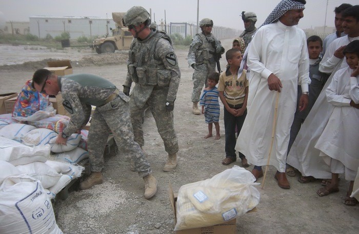 Photos courtesy 2nd Lt Christopher Molaro
Lt. Col. Robert Wright, left, picks up a bag of beans to be added to the packet of lentils and cans of tomatoes.