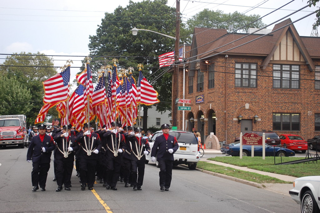 The Valley Stream Fire Department color guard passes fire headquarters on Rockaway Parkway during last Saturday's 3rd Battalion parade.