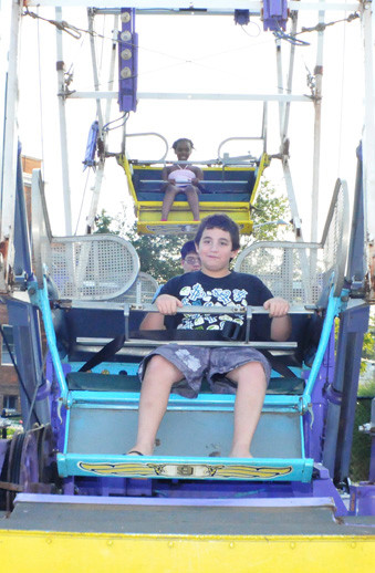 logan Rudolfsky, 11, takes a ride on the Ferris wheel, one of many rides at the four-day festival hosted last weekend by Blessed Sacrament Church.