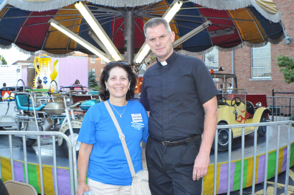 Maria Sorrentino, from the festival’s committee, is joined by The Rev. Peter Dugandzic, pastor the church who said the fair was a huge success.