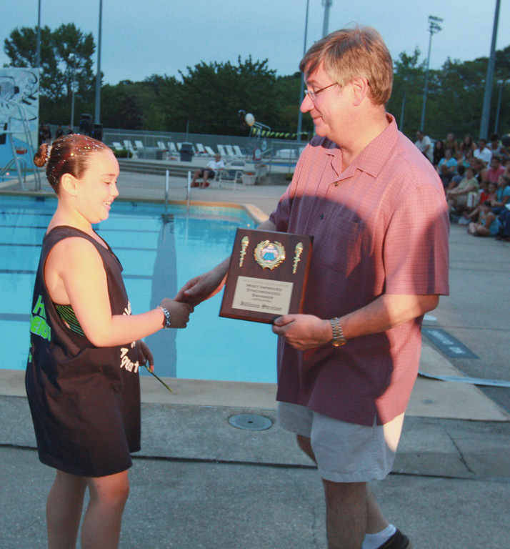 Jilliana Strojan received the Most Improved Synchronized Swimmer award from Village Justice Robert Bogle.