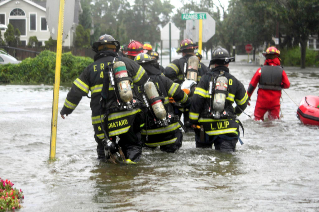 Members of the East Rockaway Fire Department waded through floodwaters in Bay Park on the way to a reported house fire.