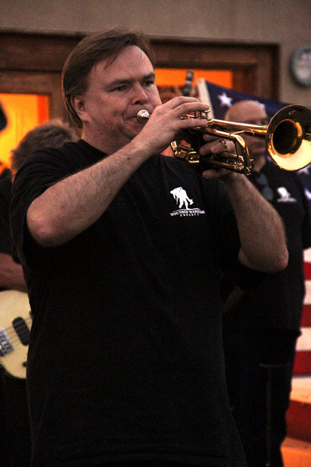 Fred Tyra plays "Taps" during a moment of silence.