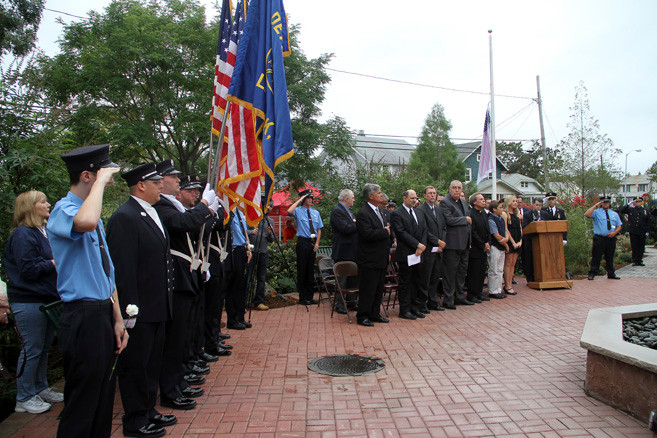 Lynbrook Firefighters and officials  saluted the flag during the Pledge of Allegiance.