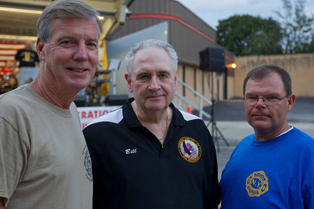 Ex-Fire Chief Steve Grogan, left, President of the Lynbrook Chamber of Commerce Bill Gaylor, and Ex-Chief of Lynbrook Fire Department Kevin Bein at the block party/fundraiser.