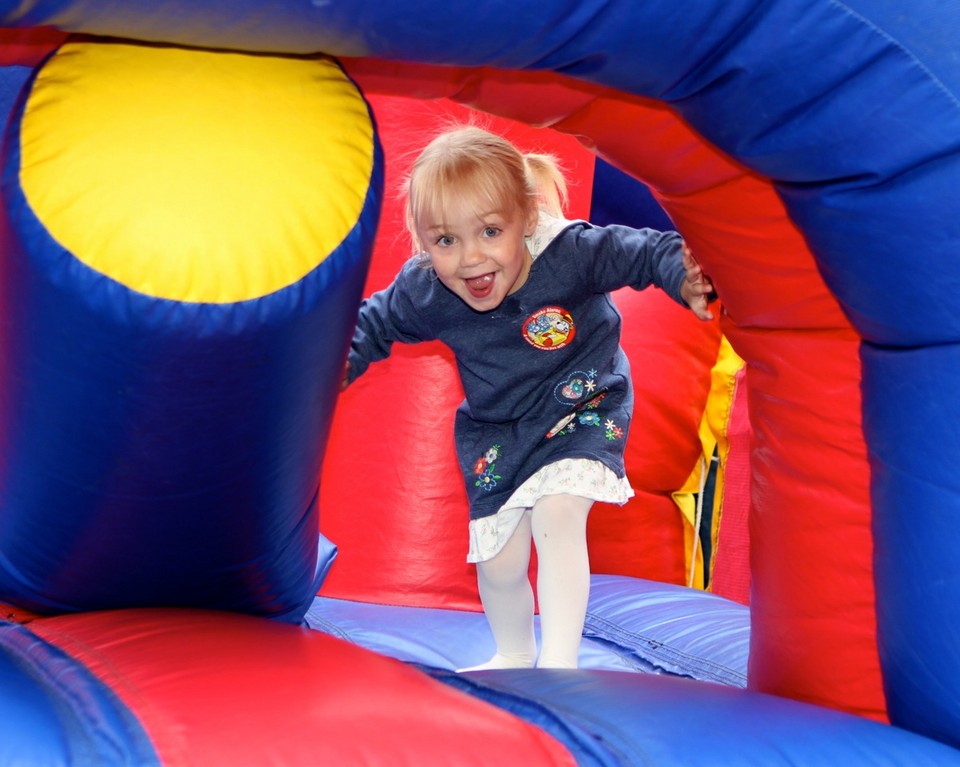 Maeve Hosford was all smiles last Saturday as she climbed through an inflatable ride at the annual Covert Avenue Chamber of Commerce Street Fair.